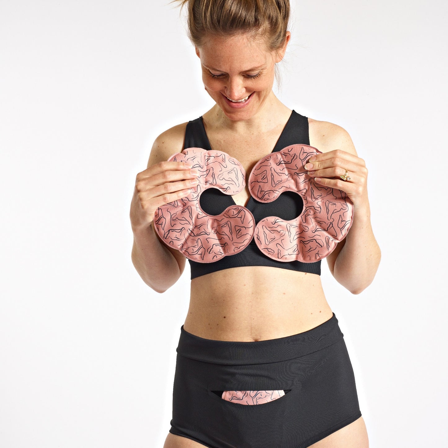 Woman holding Breast & Chest Reusable Ice/Heat Packs and wearing FourthWear