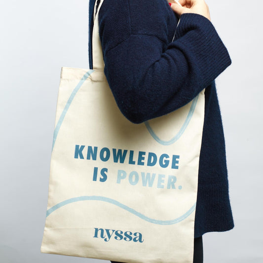 Nyssa Knowledge Is Power Tote on Shoulder.